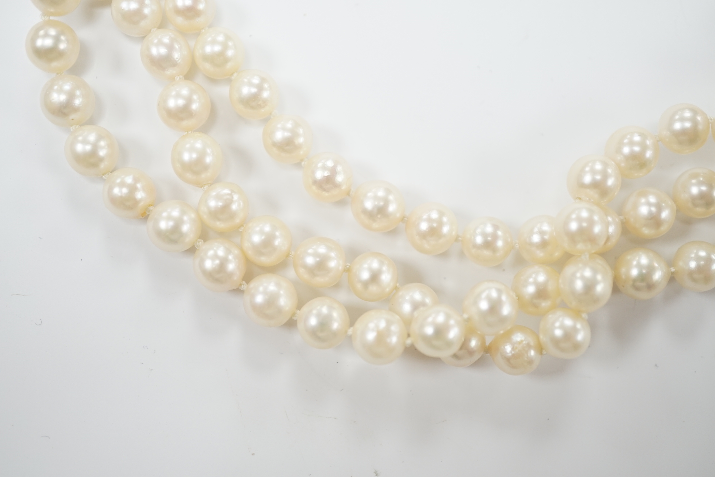 A triple strand cultured pearl set choker necklace, with 750 yellow metal and cultured pearl set clasp, 35cm.